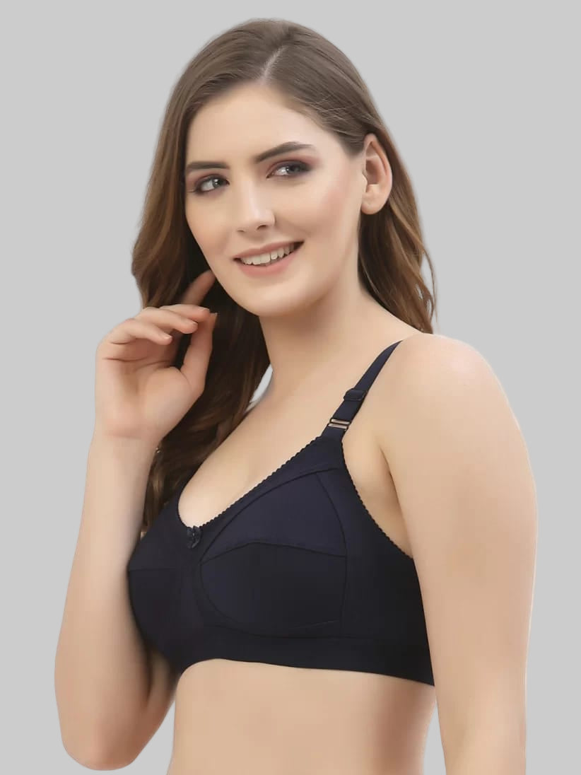 Woman wearing a black bra on a grey background