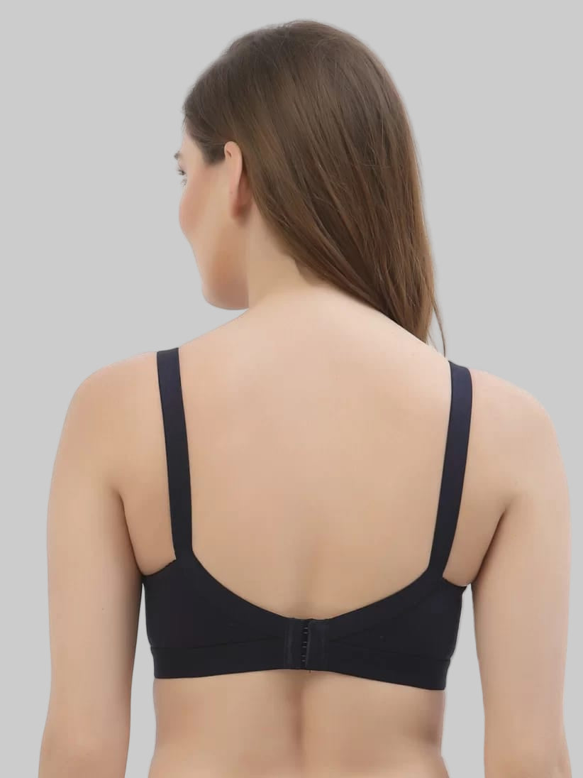 Black bra worn by a person on a grey background